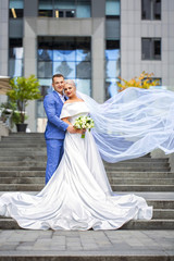 Fototapeta premium beautiful newlyweds on business center background