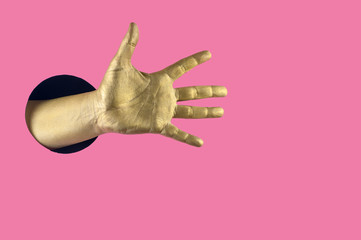 Hand painted in gold shows different gestures and symbols from the hole on a pink pastel paper background.