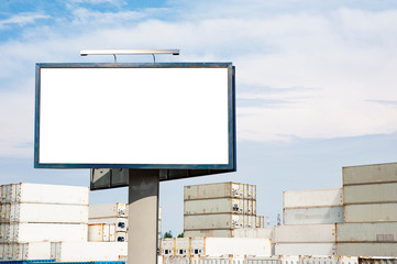Blank white advertising billboard against freight containers on a sunny summer day