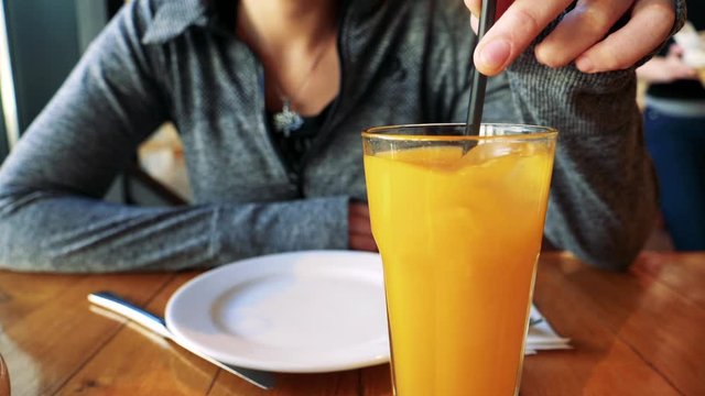 Having an orange juice for breakfast