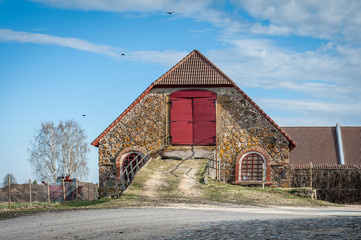 Cow barn or cattle shed in the old property. Early spring landscape. Olustvere manor. Estonia.