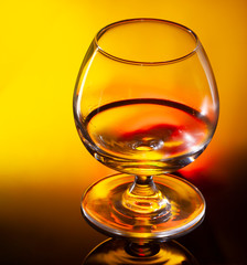 Glass of whiskey or cognac on black background with space for text on black background