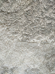 Rough texture of an old brown grey traditional wall with visible pattern of applying the cement and other materials wallpaper