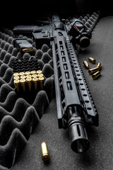 Modern automatic carbine with optical and collimator sight. A rifle with two sights on a dark...