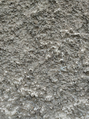 Very rough texture of an old brown grey traditional wall with visible pattern of applying the cement and other materials wallpaper