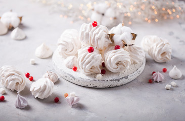 White zephyr on grey concrete background. Set of homemade marshmallow Meringue, pansy. Russian sweetness cusine