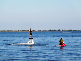 Sports activities on the lake in the recreation center in summer