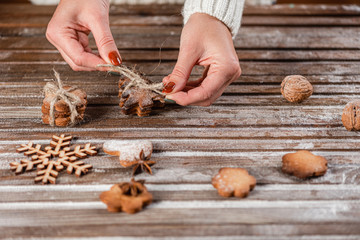 Christmas traditions. A woman is packed gifts from home baking on a wooden table. Close-up.