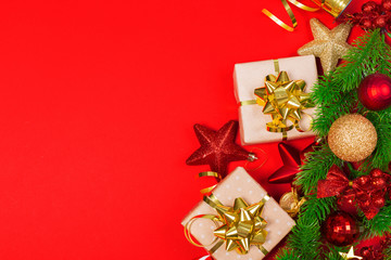 Christmas red background with herringbone and decor. Gold and red jewelry. Top view with space for copy.