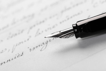 Fountain pen on an ancient handwritten letter. Old story. Retro style.