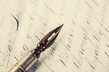 Fountain pen on an ancient handwritten letter. Old story. Retro style.