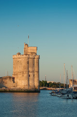 view of medieval tower at the entry of La Rochelle harbor in the morning