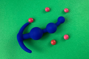 Blue anal plug for sex. On green background. Useful for sex shop or adults