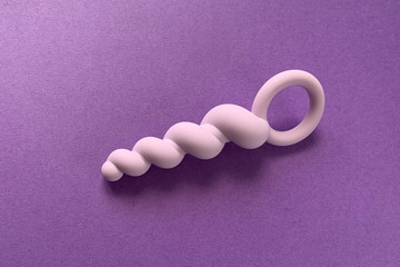 Anal plug for sex. On purple background. Useful for sex shop or adults