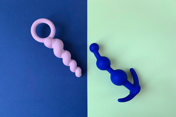 Blue and white anal plugs. Two sex toys. Two colors  background. Useful for sex shop. 