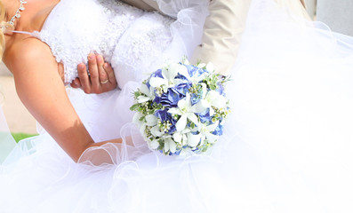 Bride holding wedding bouquet of colorful flowers