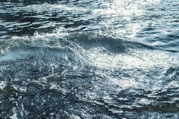 Fototapeta premium Water surface with ripples and sunlight reflections