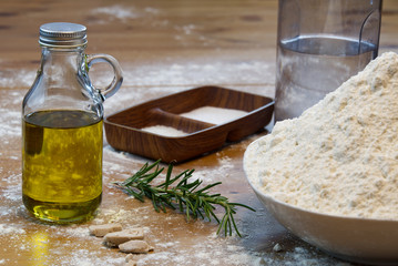ingredients for making Italian pizza dough at home. flour, salt, sugar, yeast, olive oil and water
