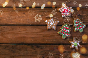 Homemade colorful gingerbread cookies on dark wooden background.