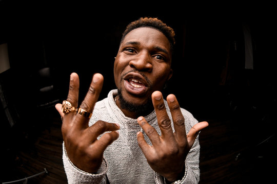 Afro american guy rapping aggressively at camera