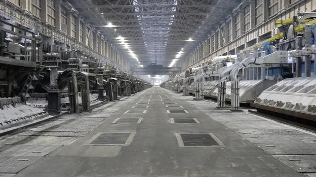 Contemporary large aluminum foundry with casting cells. Electrolytic baths in line in long workshop.
