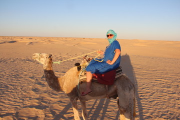 the girl on the camel in the blue dress