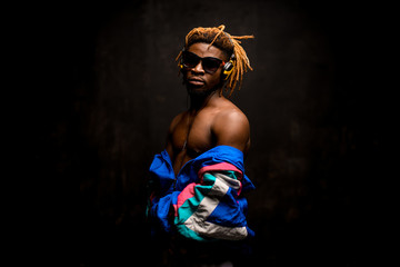 Afro american guy in glasses with bare shoulders