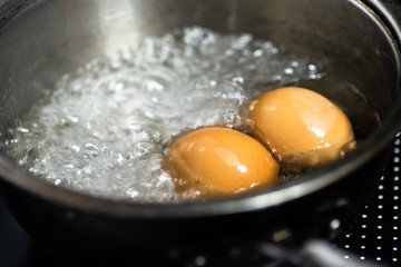 eggs in boiling water top view, close up