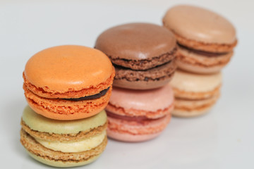 Delicious macaron sweets arranged in rows, colorful macaroon dessert on white background. -Image