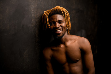 Smiling afro american guy posing with bare chest