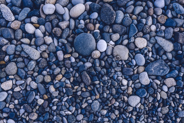Fototapeta na wymiar Stones on the beach. Blue tinting. Top view. Beach in Georgia Batumi.
