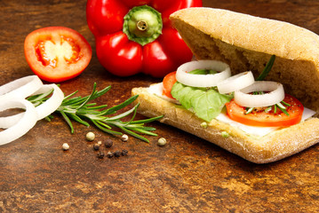 Italian ciabatta and sandwich ingredients. onion, tomato, pepper, goat cheese, razmoin, basil and avocado. Photo