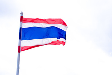 The national flag of Thailand on a flagpole, isolated on white and blue sky background, Image of waving Thai flag