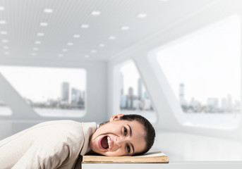 Bored business woman lying on desk