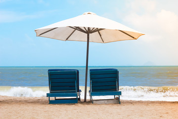 Sun beds chaise lounges against the backdrop of the sea, beach vacation, tropical vacation.
