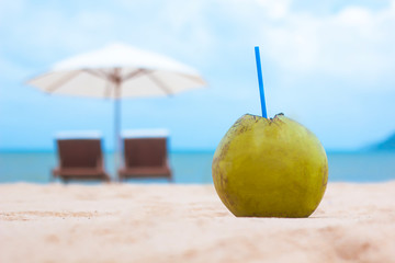 Coconut cocktail on the beach amid the sea and deck chairs. Relax concept and vacation. Copy Space