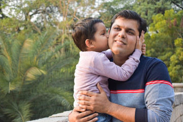 Little boy kissing his father