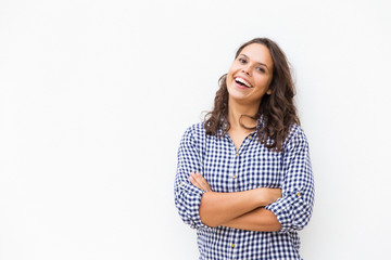 Happy joyful female customer standing with arms folded near blank copy space. Young woman in casual checked shirt posing isolated over white background. Advertising concept