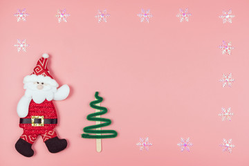 Christmas background concept.,Top view christmas decoration santa claus, christmas tree and snowflake on pastel or pink background with copy space for text.