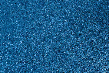 Fototapeta na wymiar Sea sand tinted with 2020 classic blue trend color. The texture of coarse sea sand in classic blue color.