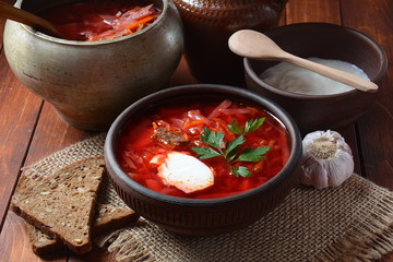 Traditional Ukrainian Russian borscht . Bowl of red beet root soup borsch with white cream . Beet Root delicious soup . Traditional Ukrain food cuisine 