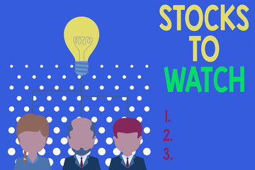 Obraz premium Writing note showing Stocks To Watch. Business concept for being heavy broker and watch every increase decrease Group three executive persons sharing idea icon. Startup team meeting