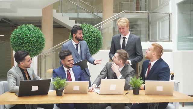 Group of diverse young business executives holding a meeting in office.