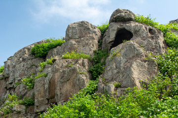Fototapeta na wymiar Mountain with rocks and green grass.