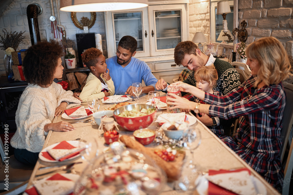 Wall mural Happy families enjoying Christmas dinner