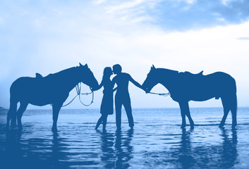 People in love at sunset in the sea