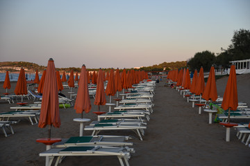 Obraz premium Umbrellas on the Beach at Sunset by Summer