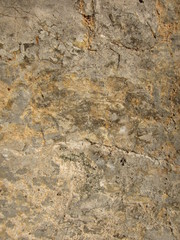 Texture of a sedimentary limestone rock with cracks