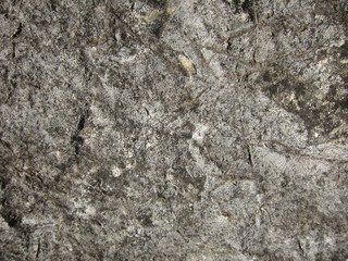 Texture of a sedimentary limestone rock with cracks