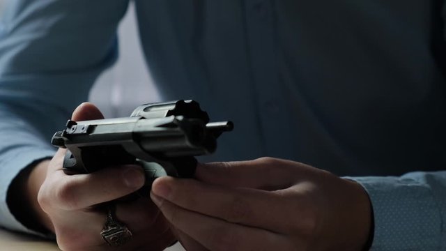 Gun in the hands of a criminal or policeman, closeup